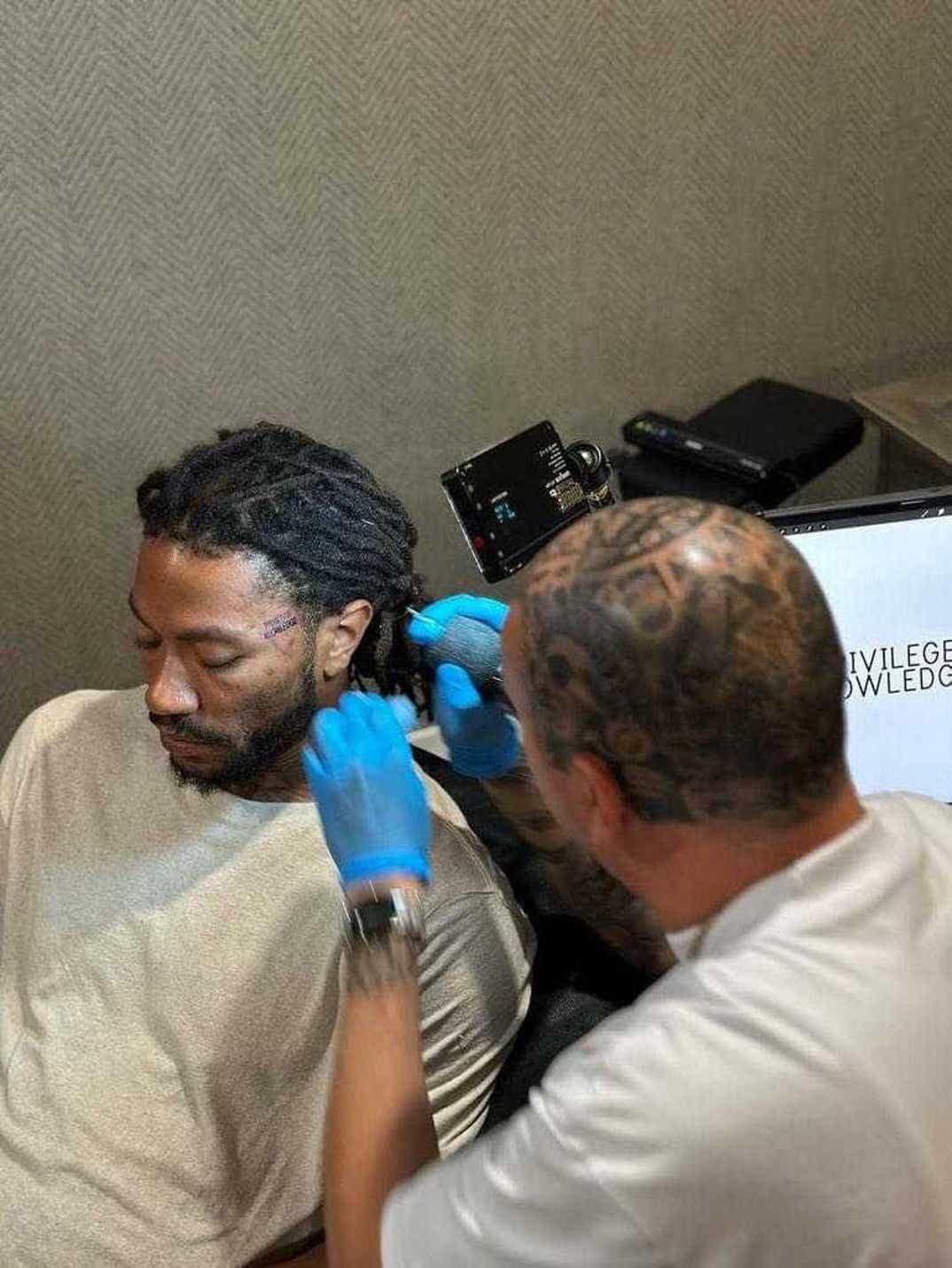 Derrick Rose’s face and neck tattoos during a tattoo session