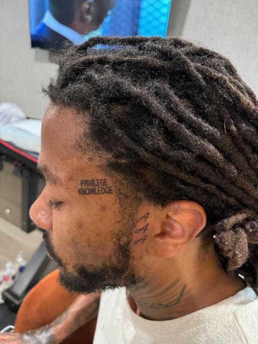 Close-up of Derrick Rose’s Privilege Knowledge and AAA tattoos
