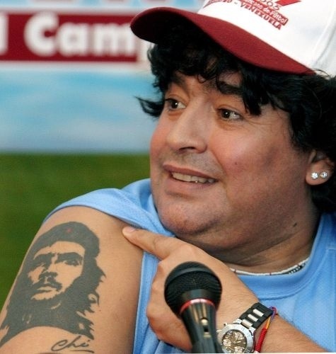 Diego Maradona showing his Che Guevara portrait tattoo on his upper arm