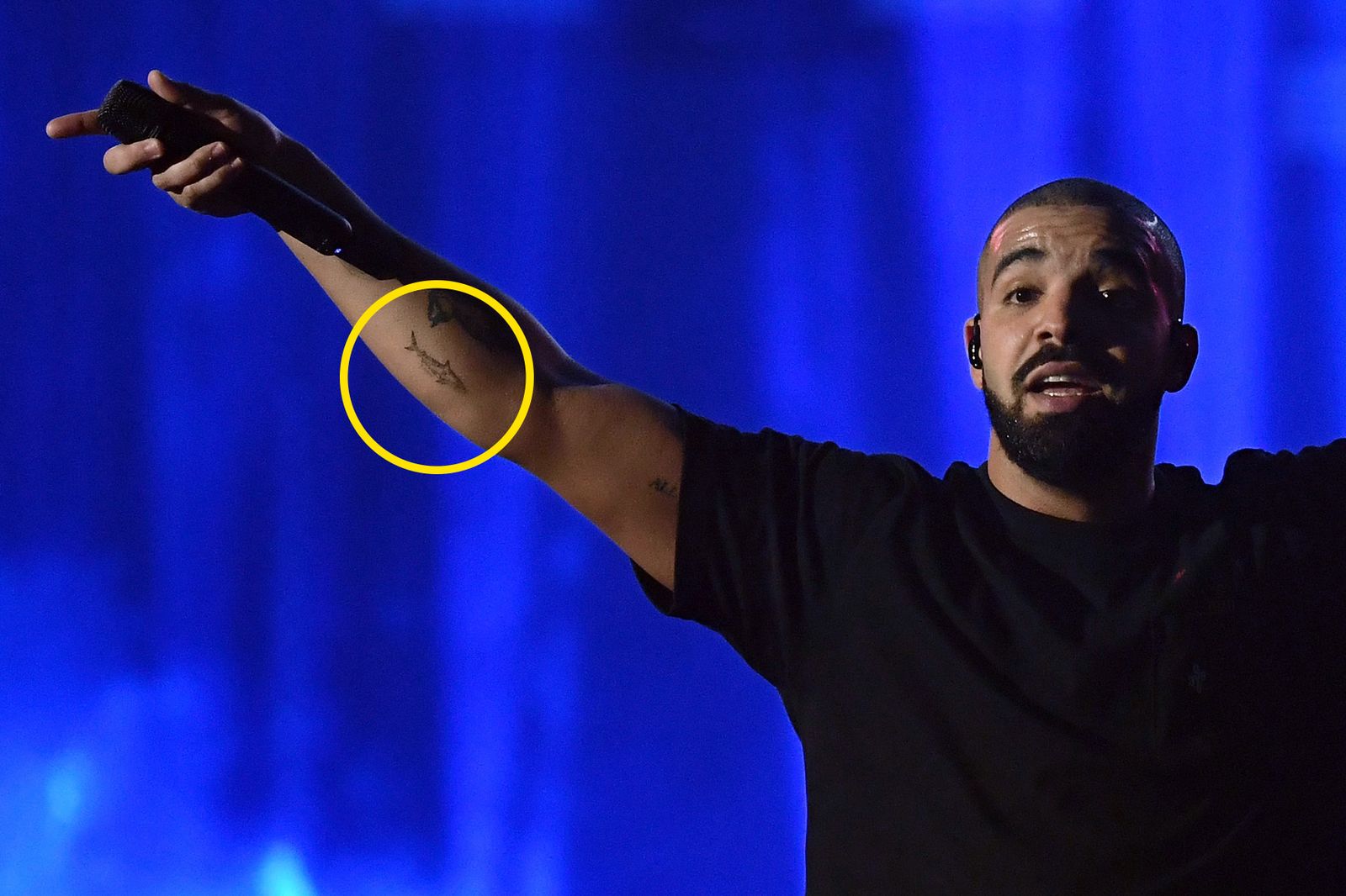 Drake showing his tattooed arm