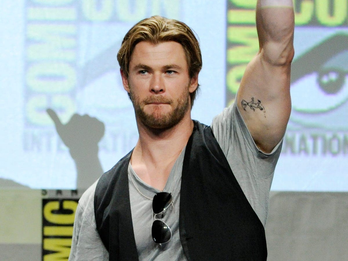 Chris Hemsworth showing the Dr. Seuss character tattoo on his upper arm
