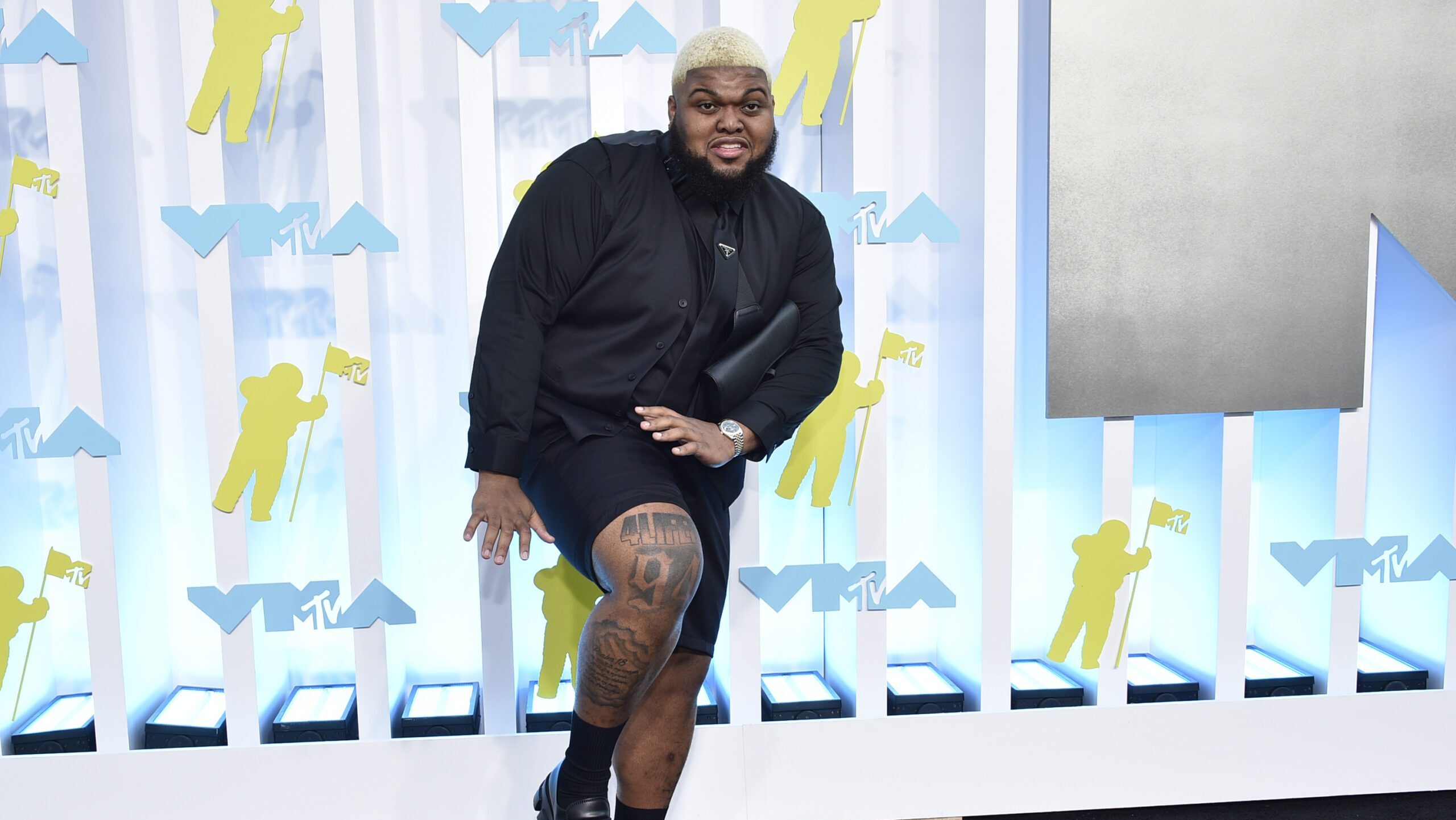 Druski leg tattoo collection at a GQ event