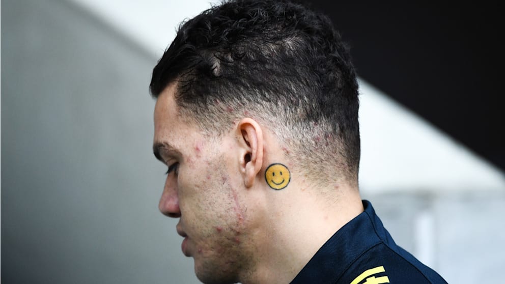 Ederson Moraes smiley face tattoo behind ear