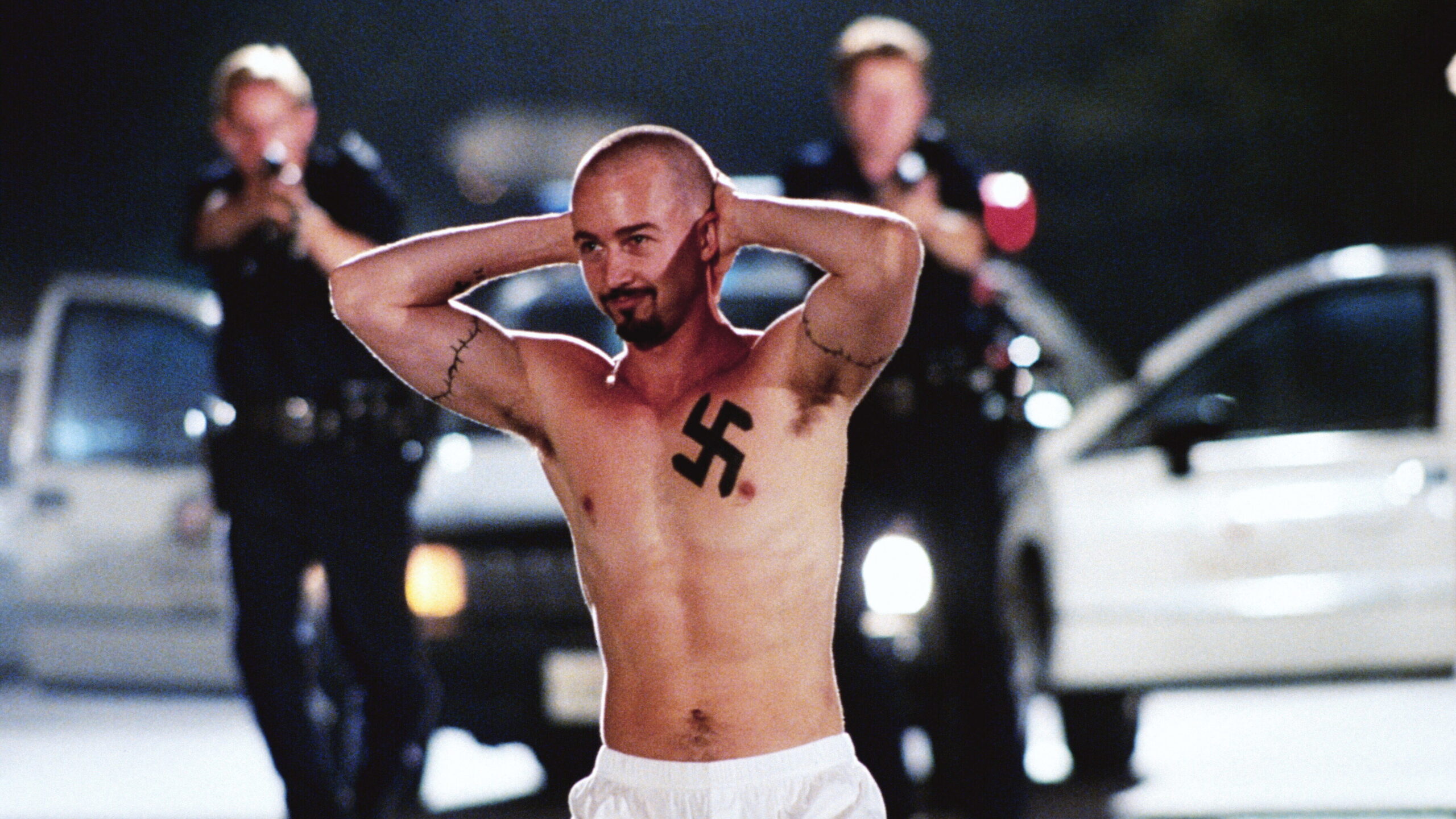 Edward Norton as Derek Vinyard with the movie tattoos visible across his chest and arms