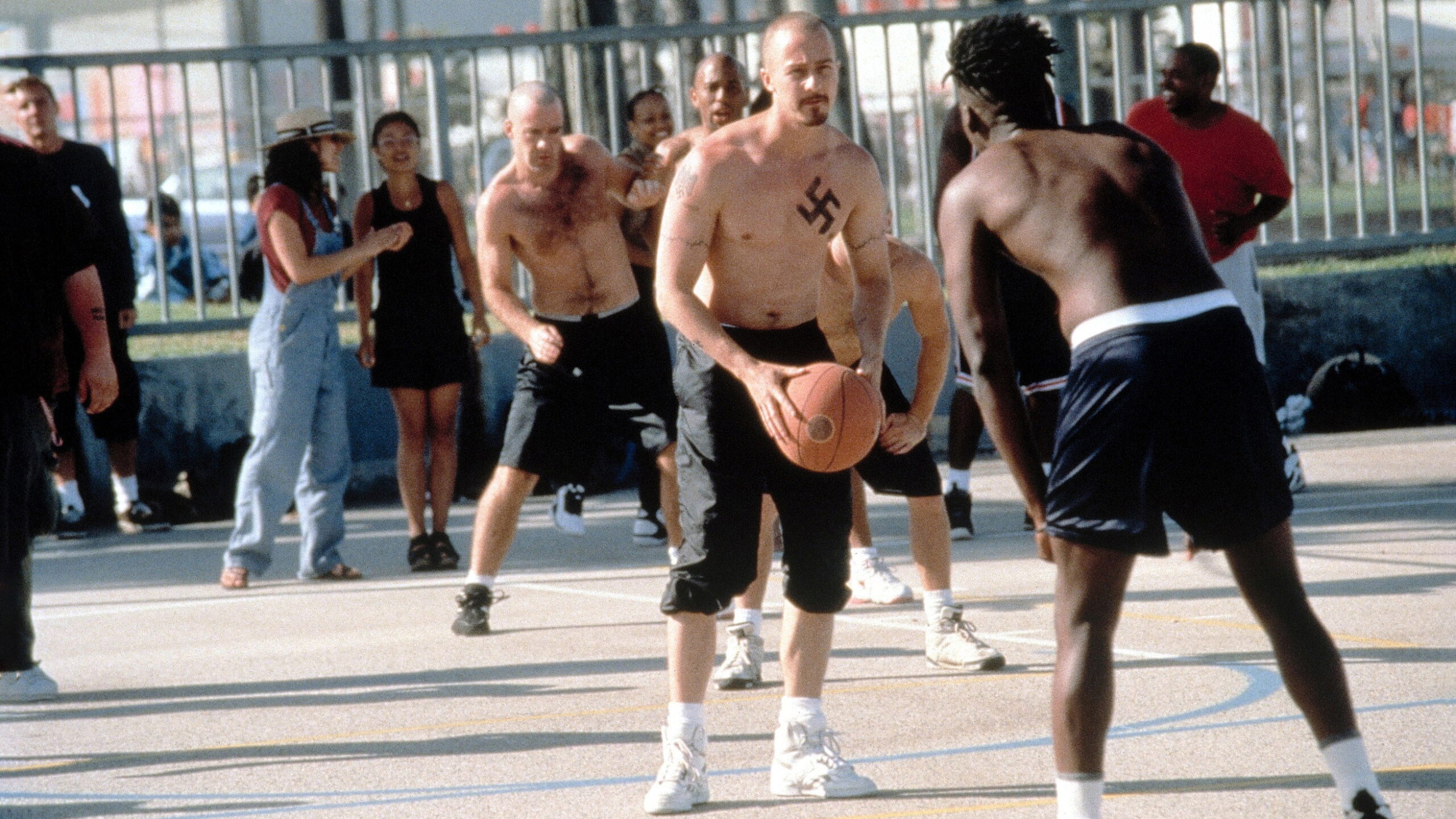 Edward Norton as Derek Vinyard playing basketball with the American History X chest tattoo makeup visible
