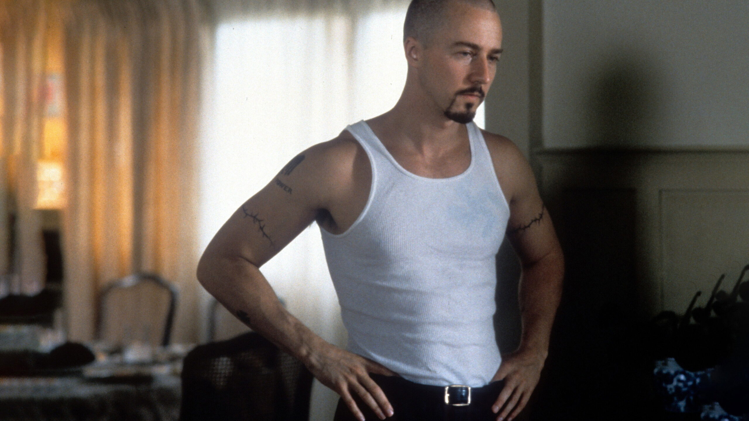 Edward Norton in a tank top with Derek Vinyard's temporary upper arm tattoos visible