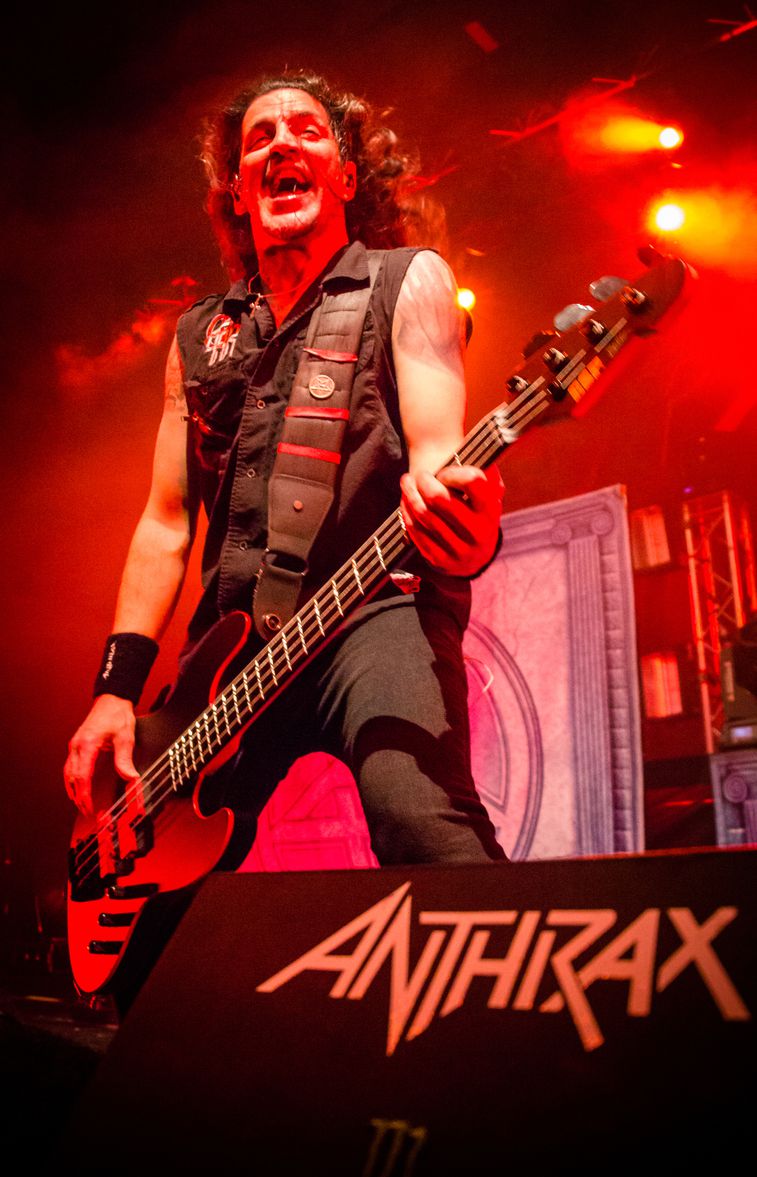 Frank Bello tattooed arm under red stage lights