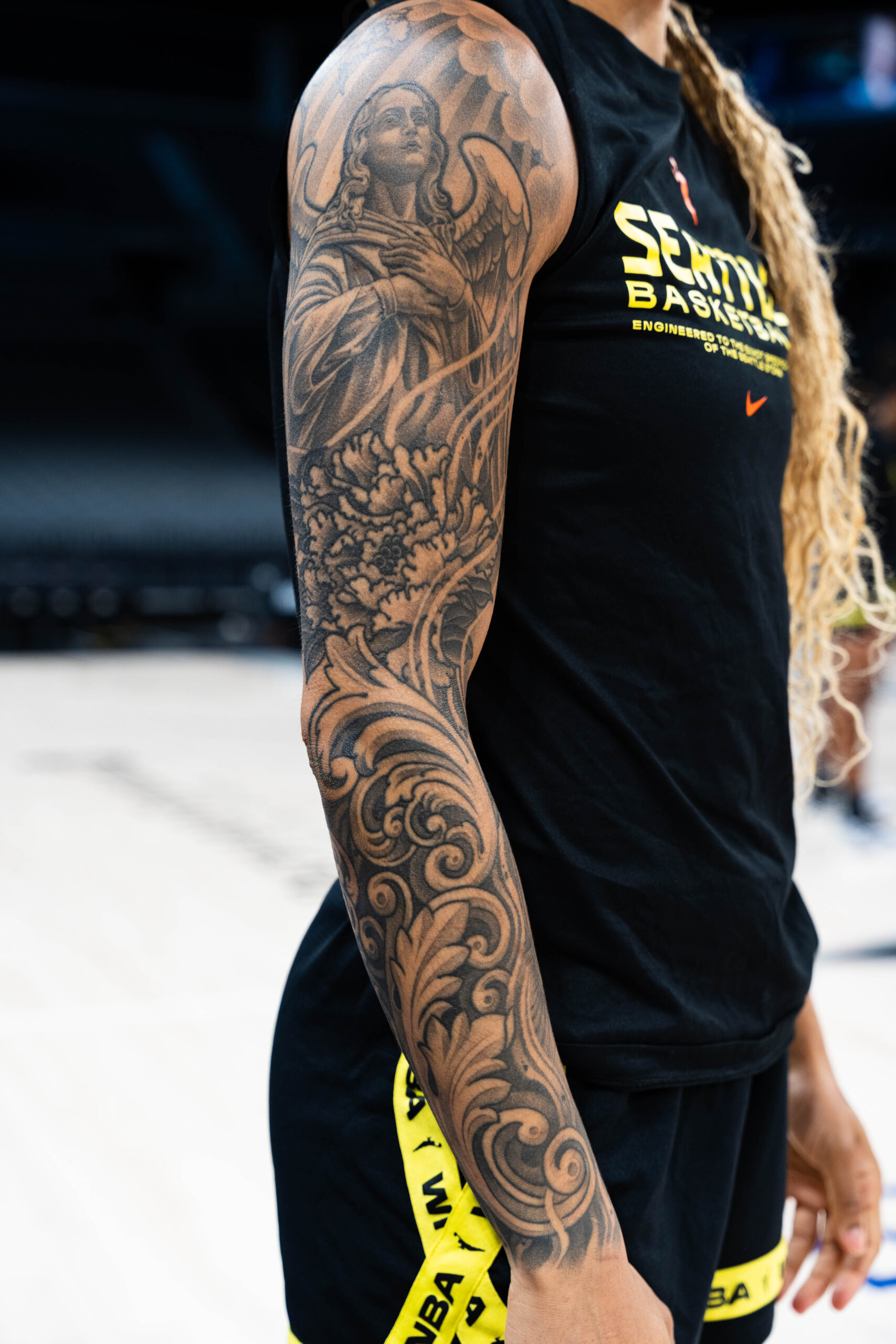 Gabby Williams black-and-gray arm sleeve tattoo