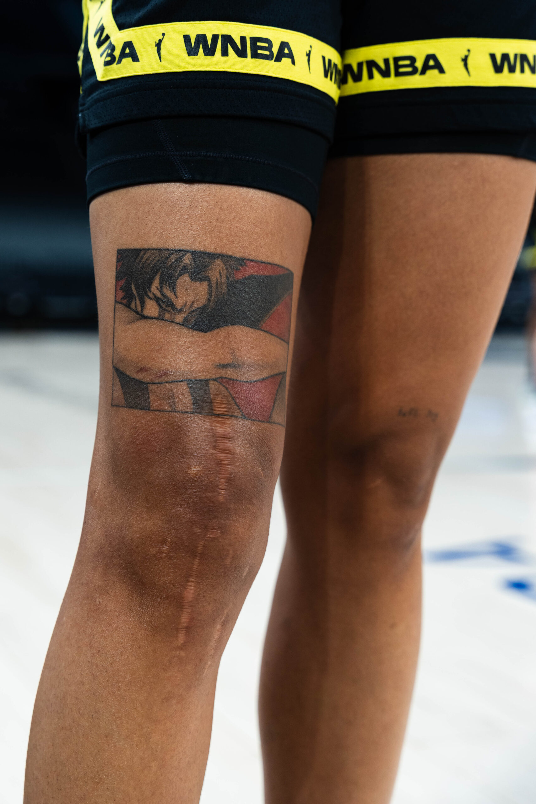 Gabby Williams finger tattoos including Prince symbol and cross