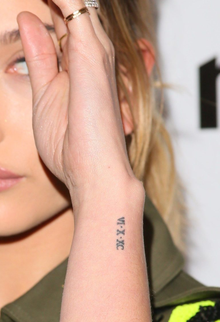 Hailey Bieber ribbon tattoo