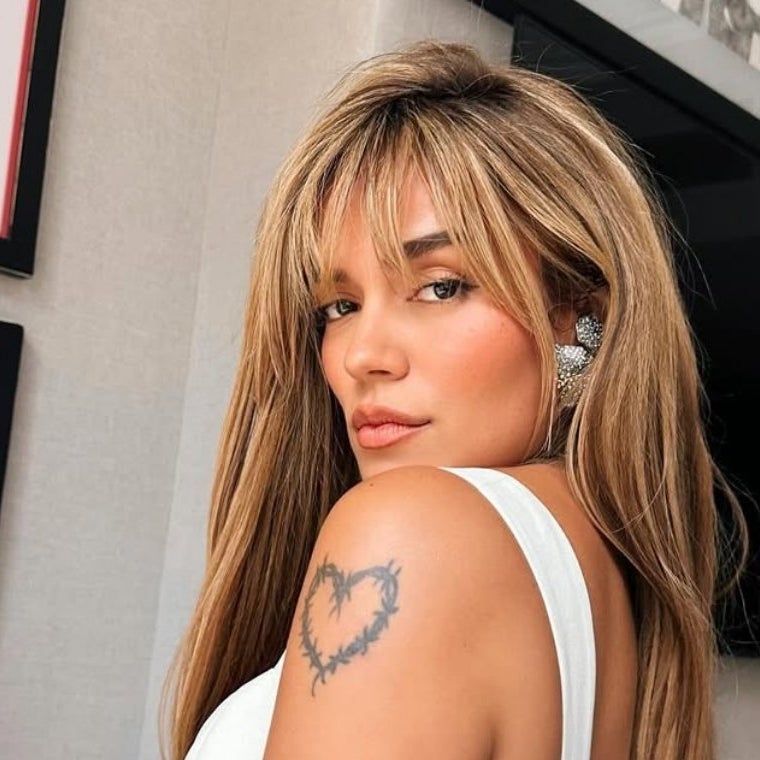 Karol G’s thorn-wrapped heart tattoo on her upper arm
