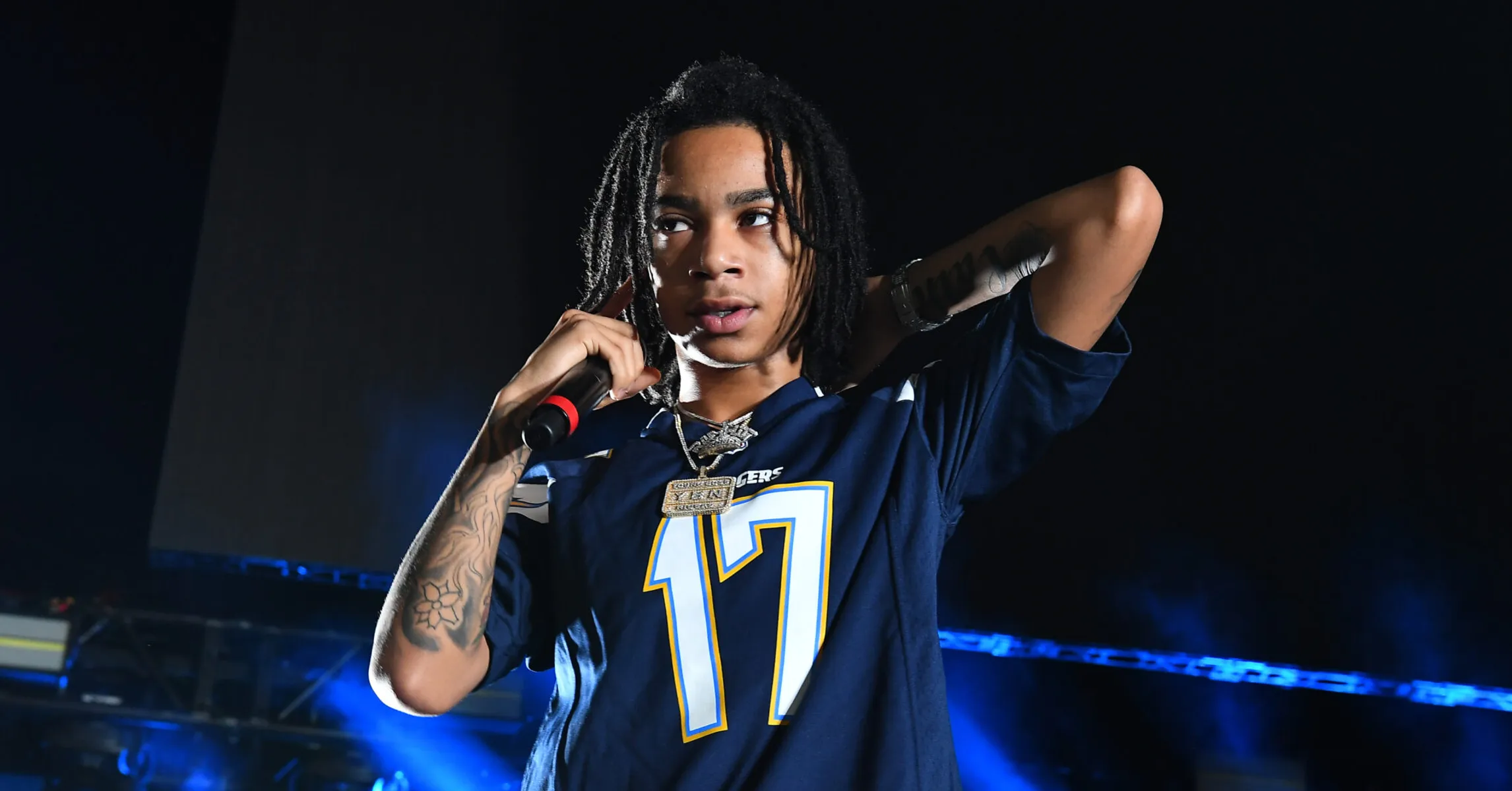YBN Nahmir on stage with his tattooed forearm visible