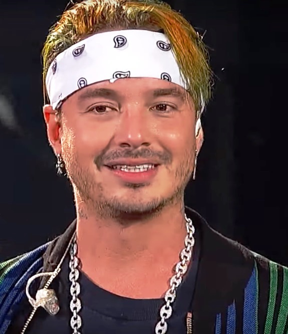 J Balvin showing his hand lettering tattoos including loyalty