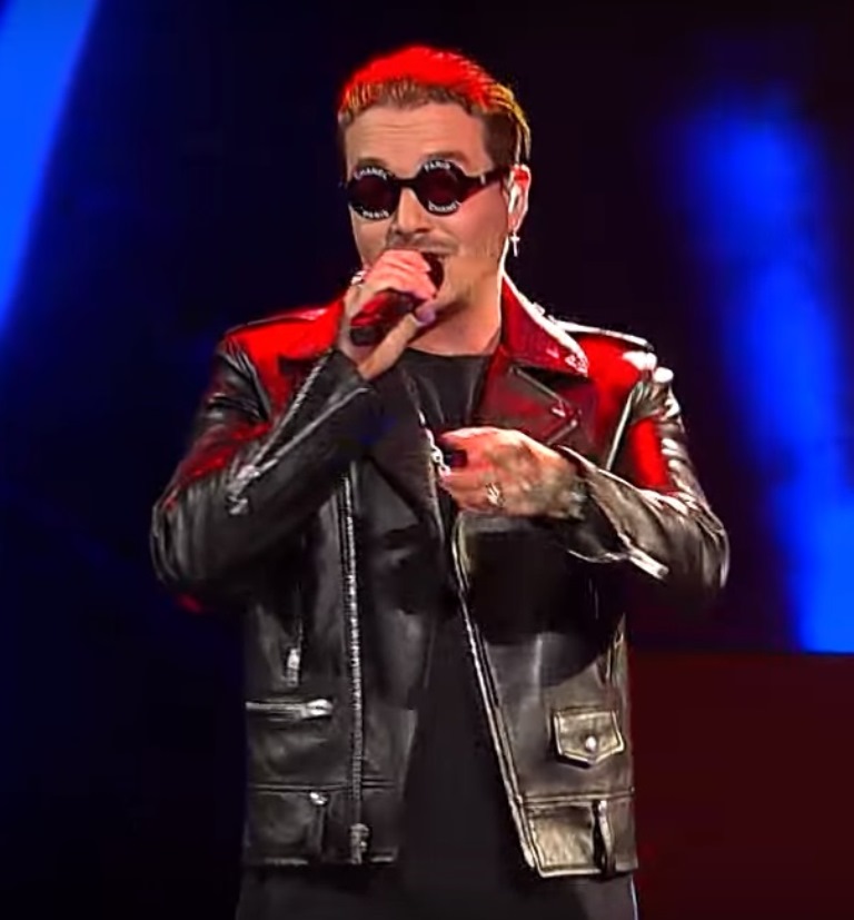 J Balvin showing family and woman portrait tattoos