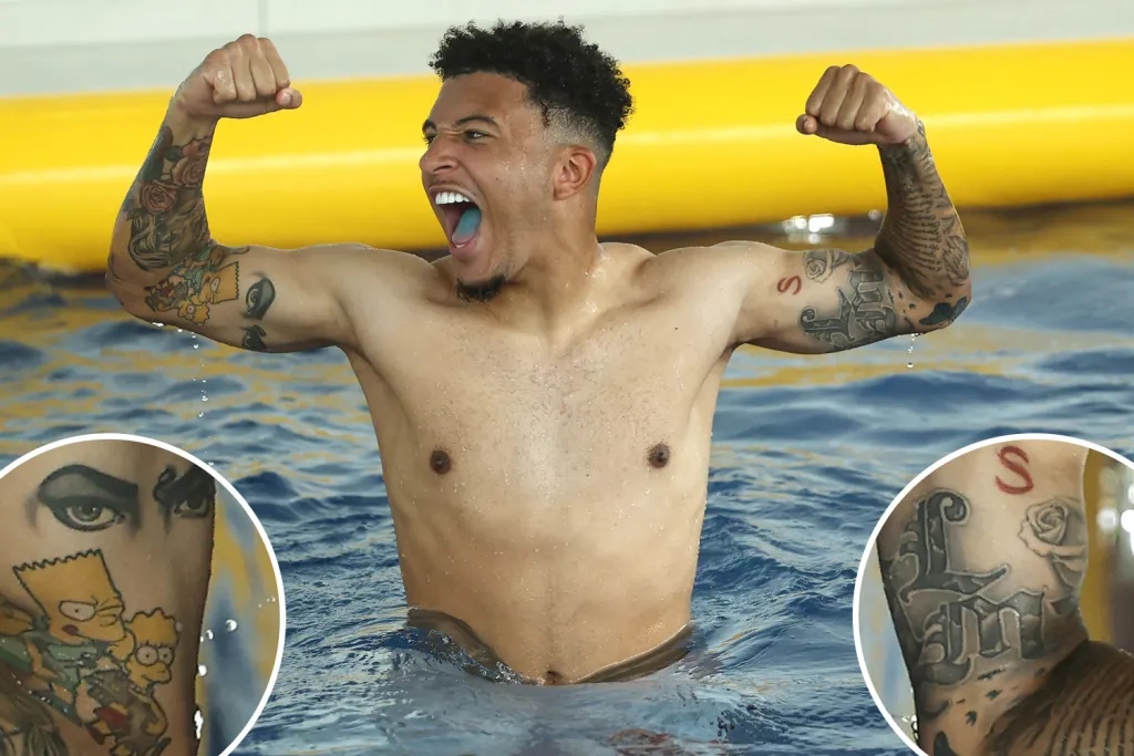 Jadon Sancho Simpsons tattoo and family initials on arm