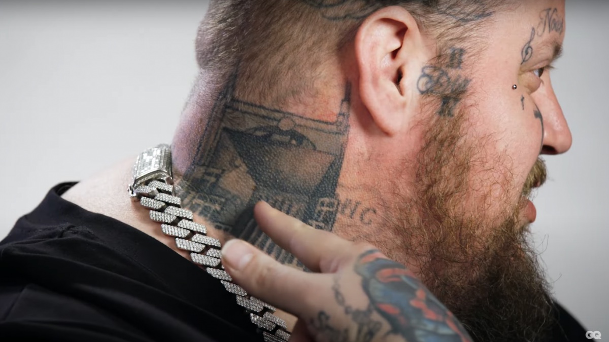 Side profile showing Jelly Roll’s Nashville skyline neck tattoo and nearby face ink