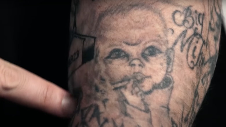 Close-up of Jelly Roll’s smoking baby tattoo on his arm