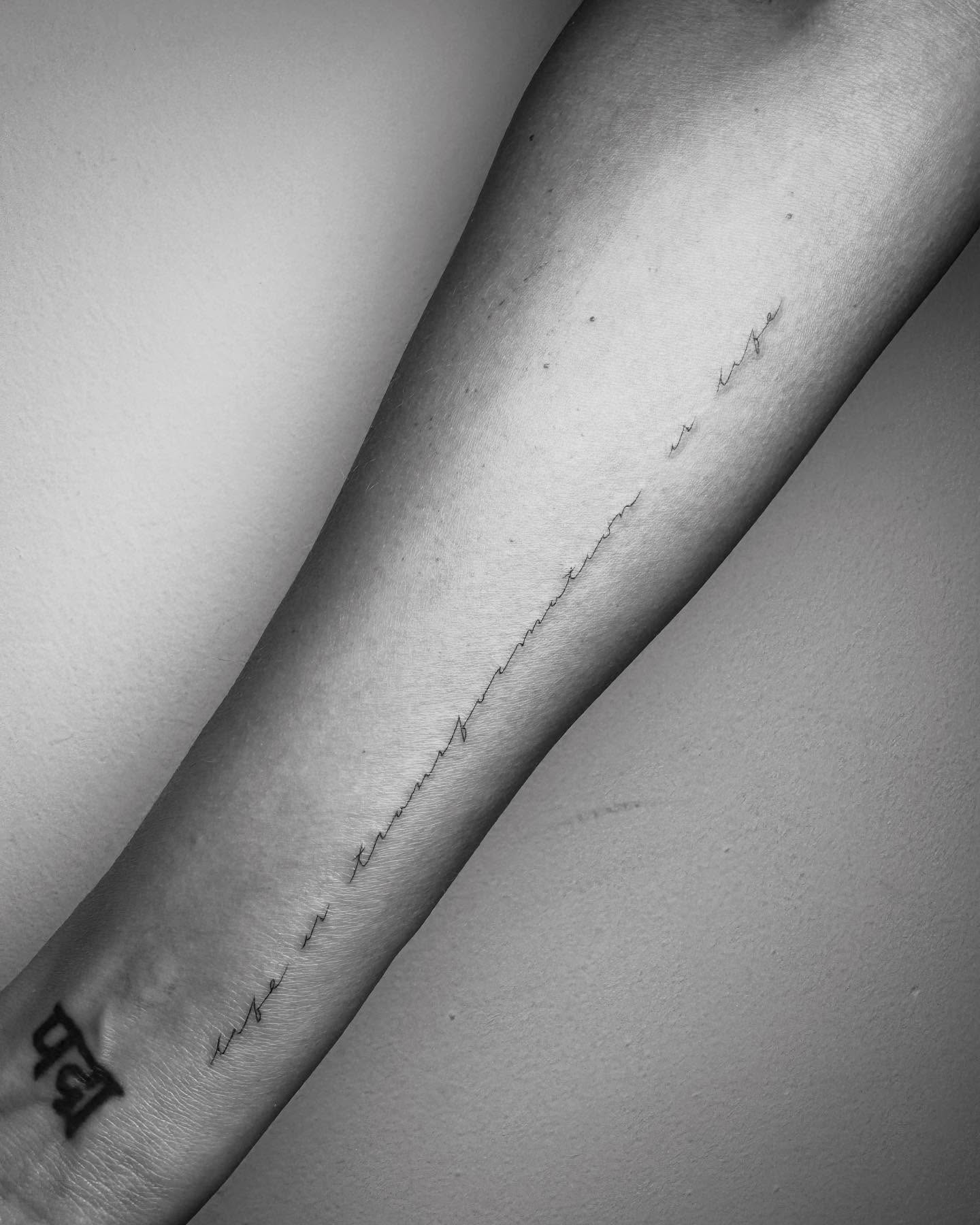 Jessica Alba life is transformation is life script tattoo close-up