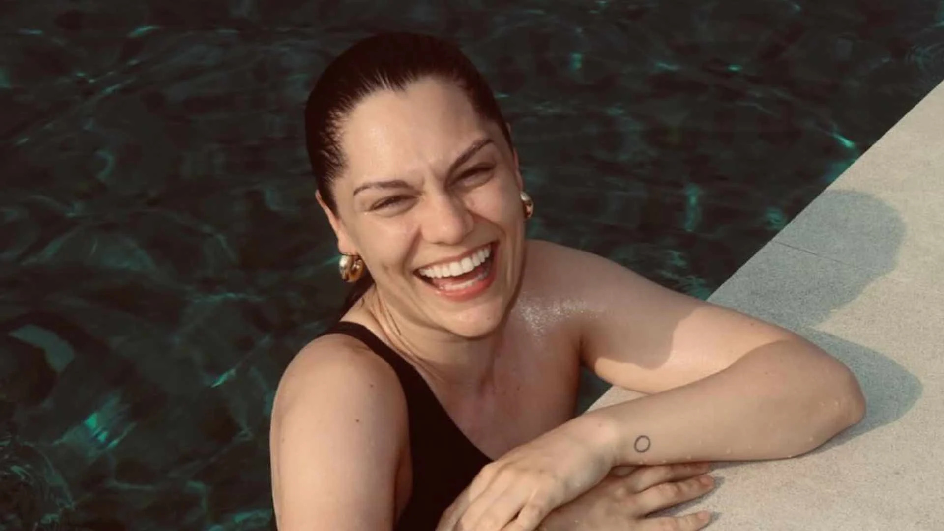 Jessie J circle wrist tattoo by the pool