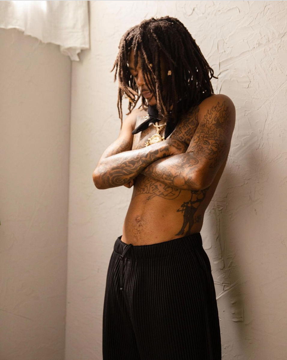 J.I.D showing the chest and torso tattoos in a close portrait