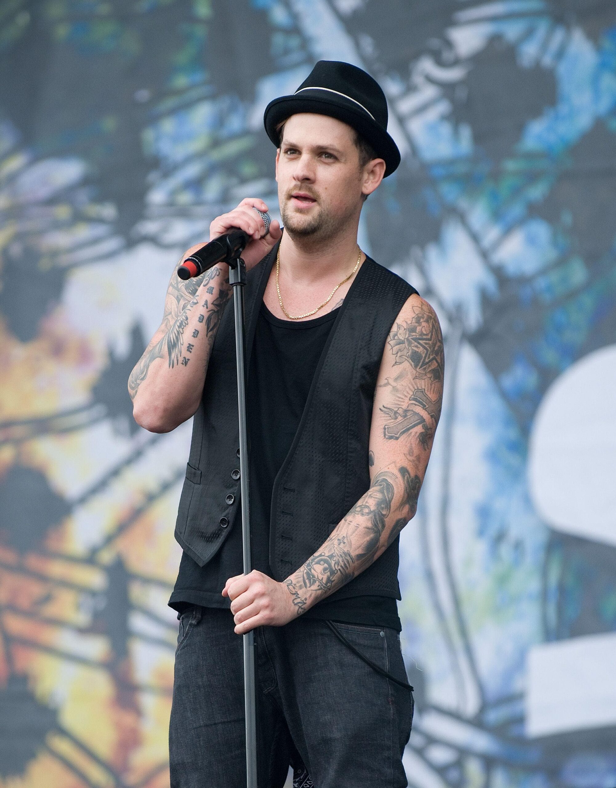 Joel Madden forearm tattoos, including lettering and black and grey work
