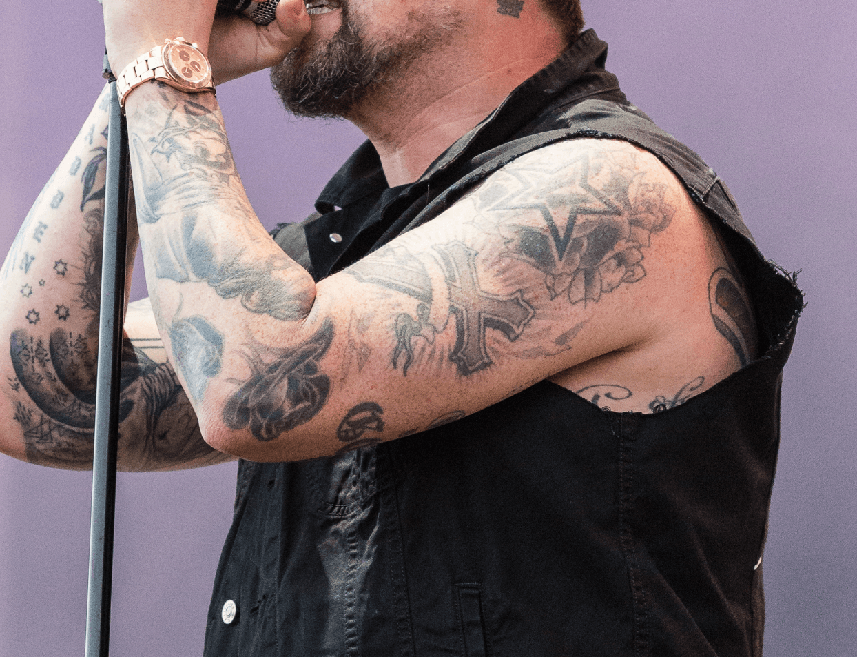 Joel Madden shoulder and bicep tattoos seen during a live performance