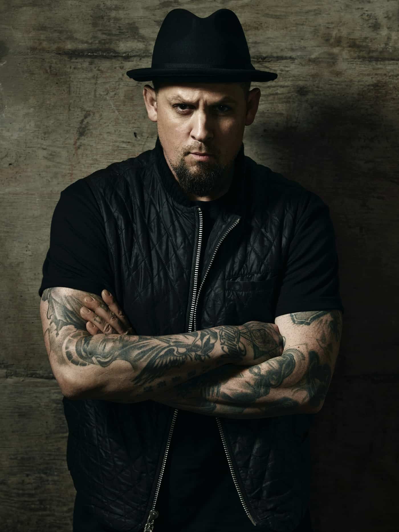 Joel Madden tattoos shown across both arms in a portrait