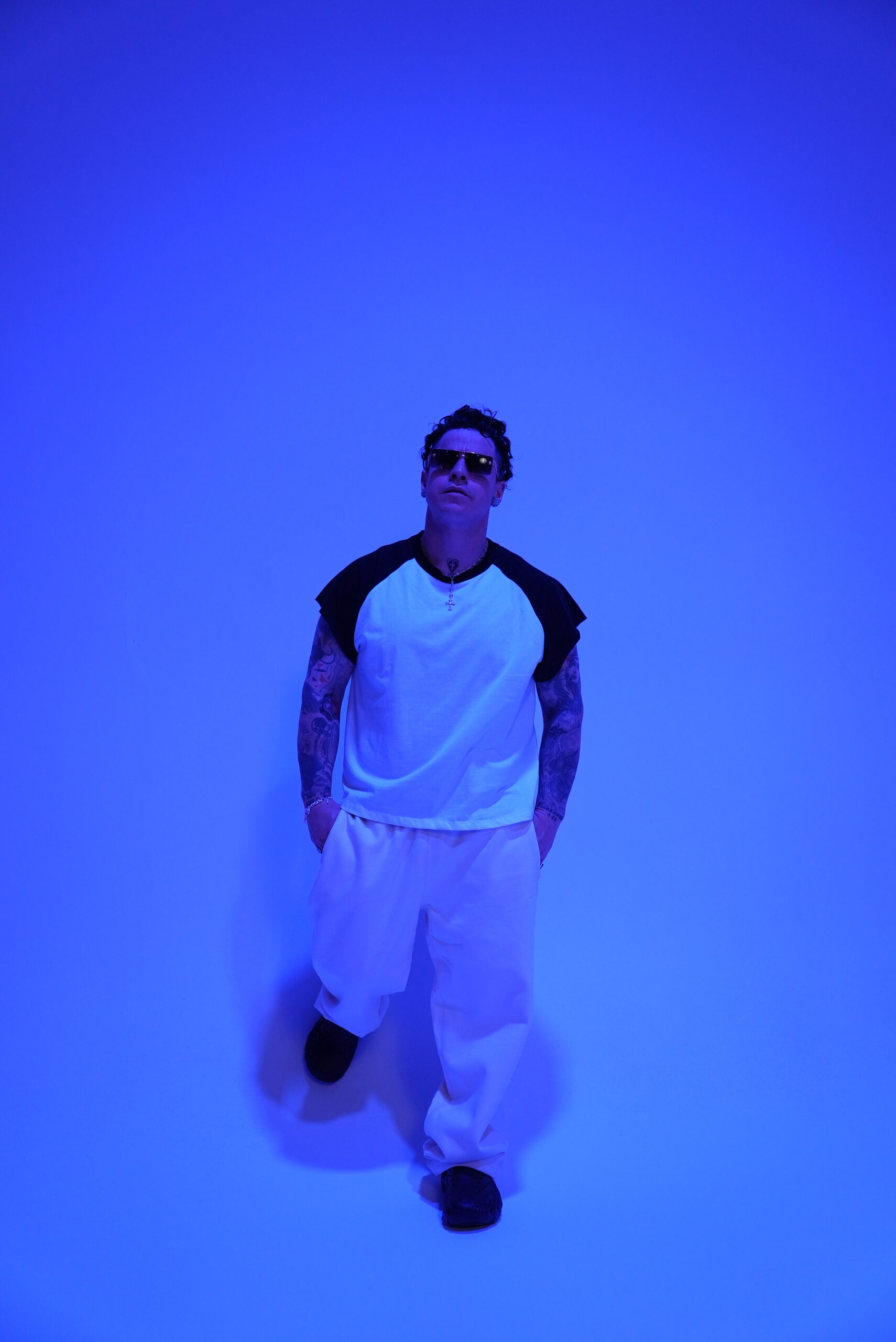 Joey Stylez blue-light tattooed arms