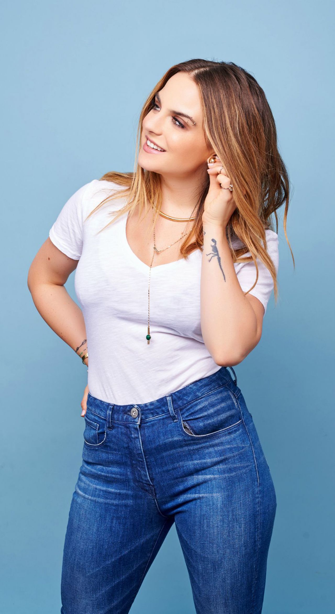 JoJo Levesque showing the script tattoos and ink on her forearm