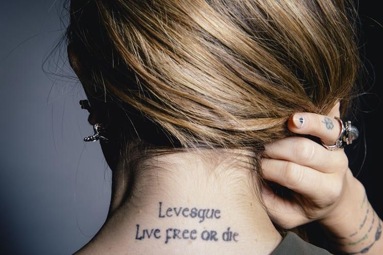 JoJo’s back-neck tattoos reading Levesque and Live Free or Die