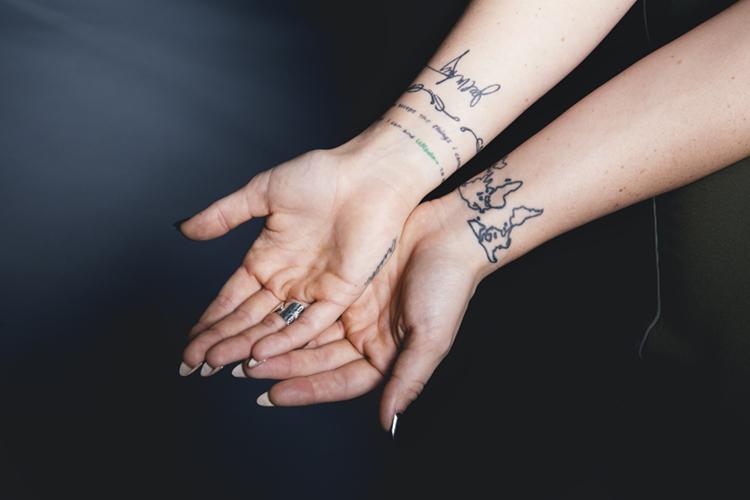 JoJo in a portrait with the small hand and wrist tattoos visible