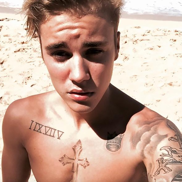 Justin Bieber’s chest cross and Roman numeral tattoos