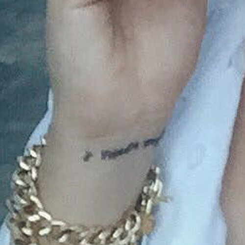 Kali Uchis writing tattoo on her wrist