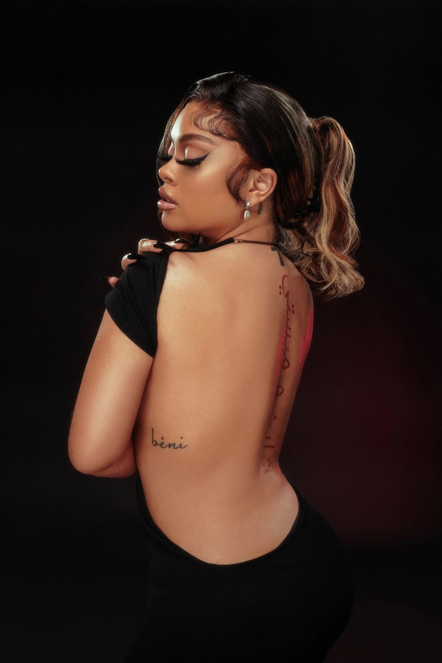 Latto Arabic spine tattoo and side tattoo visible