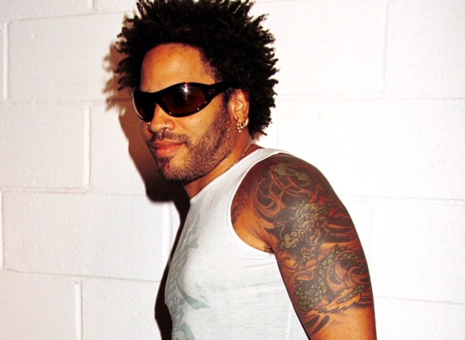 Lenny Kravitz showing the large dragon tattoo across his chest, shoulder and upper left arm