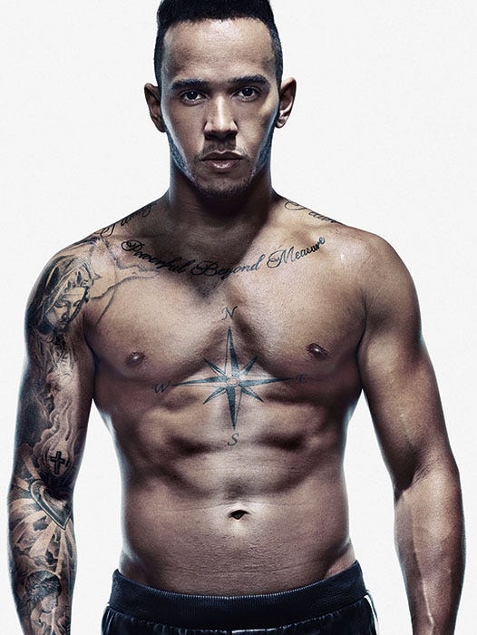 Lewis Hamilton showing the compass and Powerful Beyond Measure chest tattoos