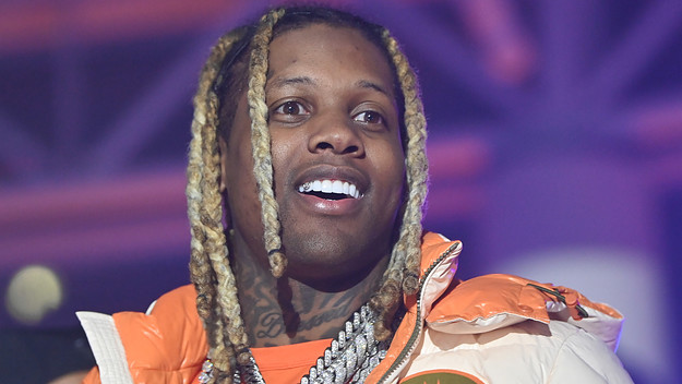 Lil Durk performing with face and arm tattoos visible