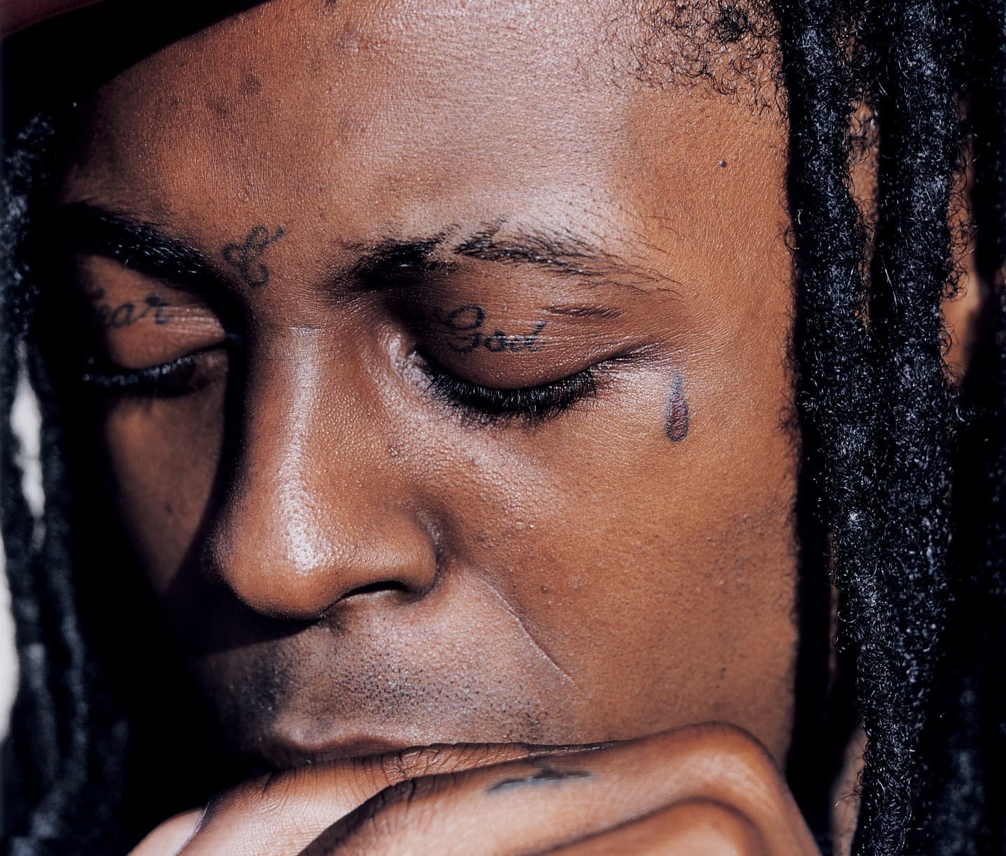 Lil Wayne Fear God eyelid and teardrop face tattoos