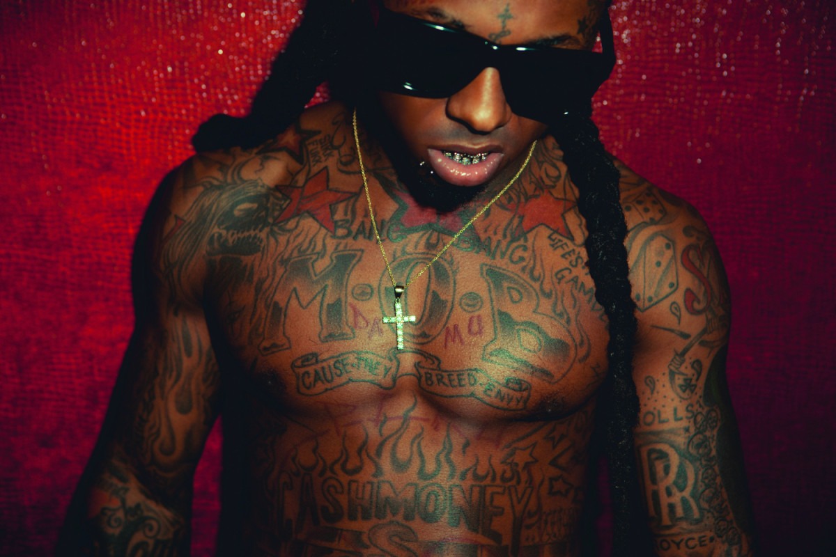Lil Wayne showing his chest and arm tattoos
