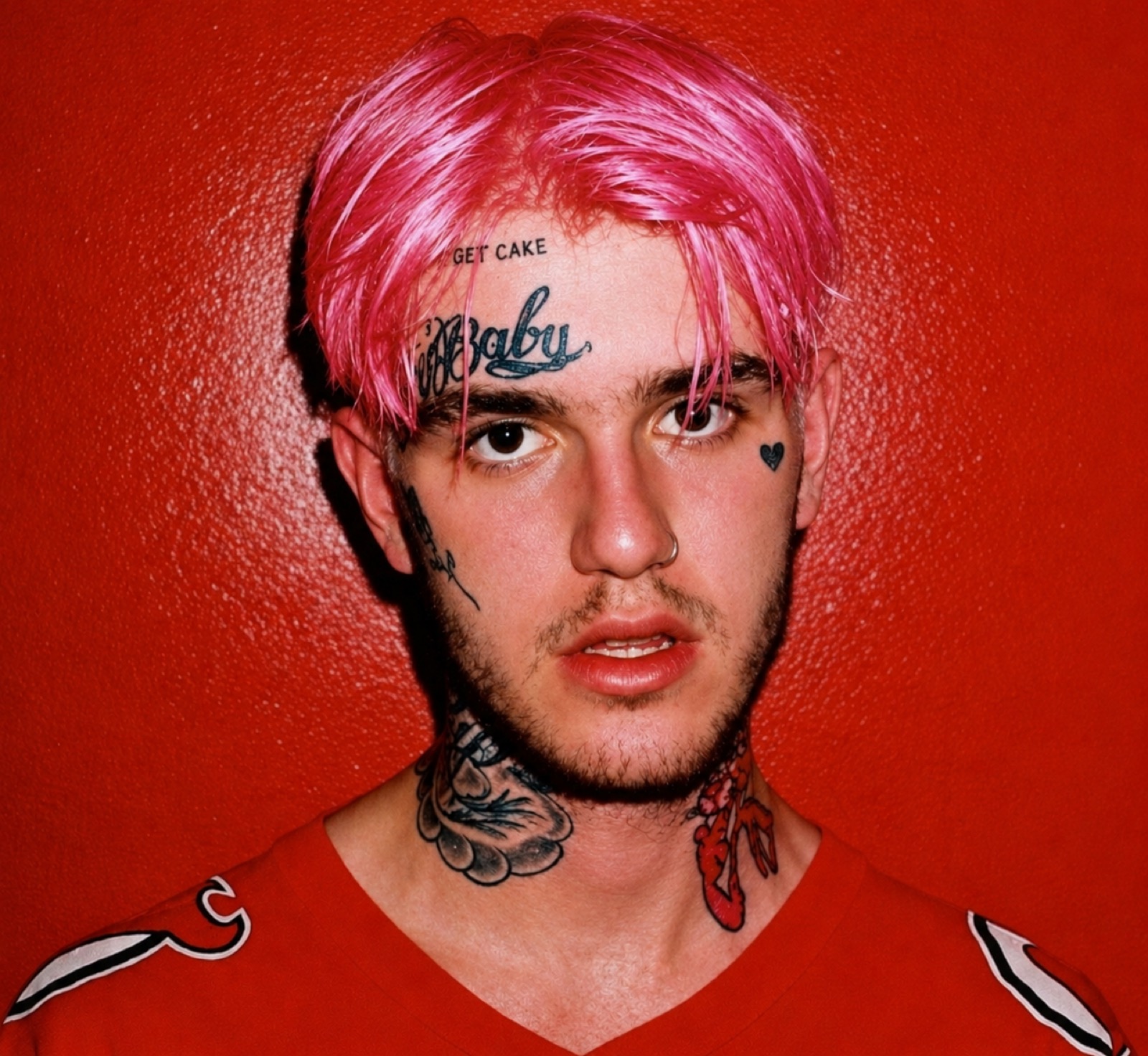 Lil Peep showing his arm and body tattoo collection