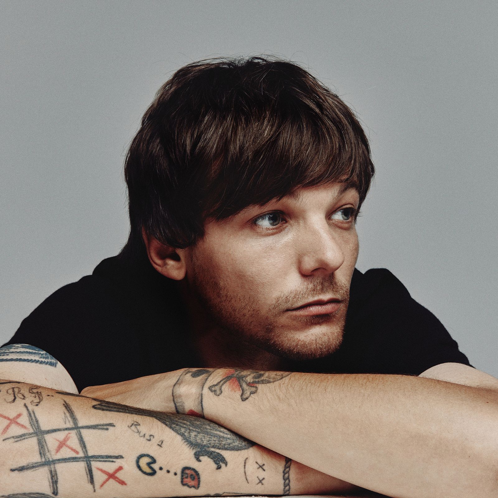 Louis Tomlinson GQ tattoo tour showing his arm tattoos