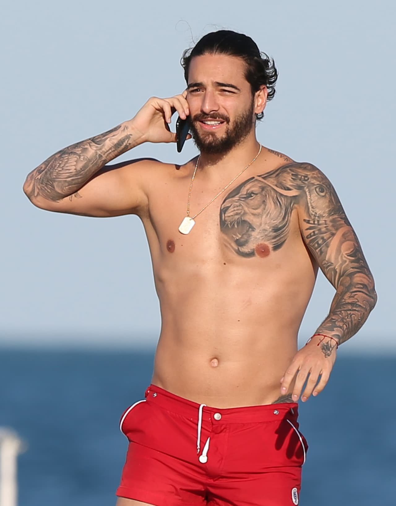 Maluma showing additional family-related tattoos on his arm