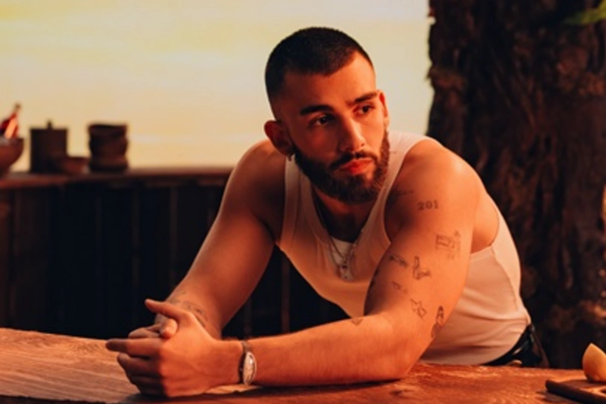 Manuel Turizo arm tattoos in a sunset portrait