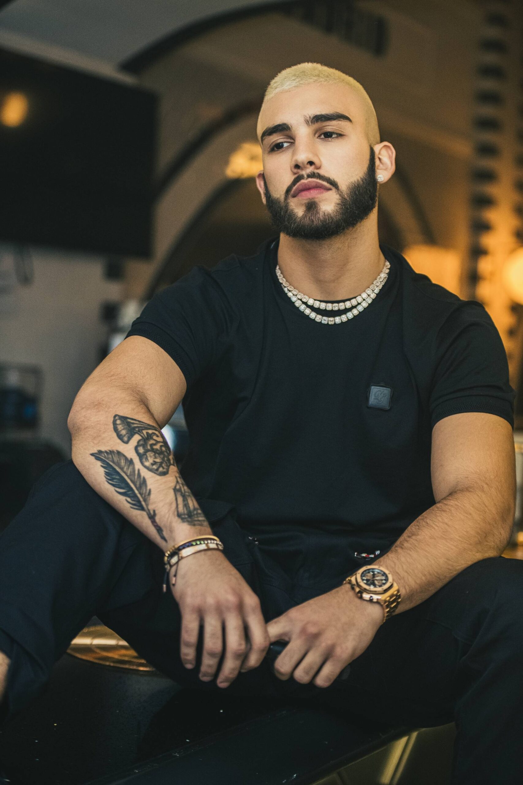 Manuel Turizo feather arm tattoo portrait