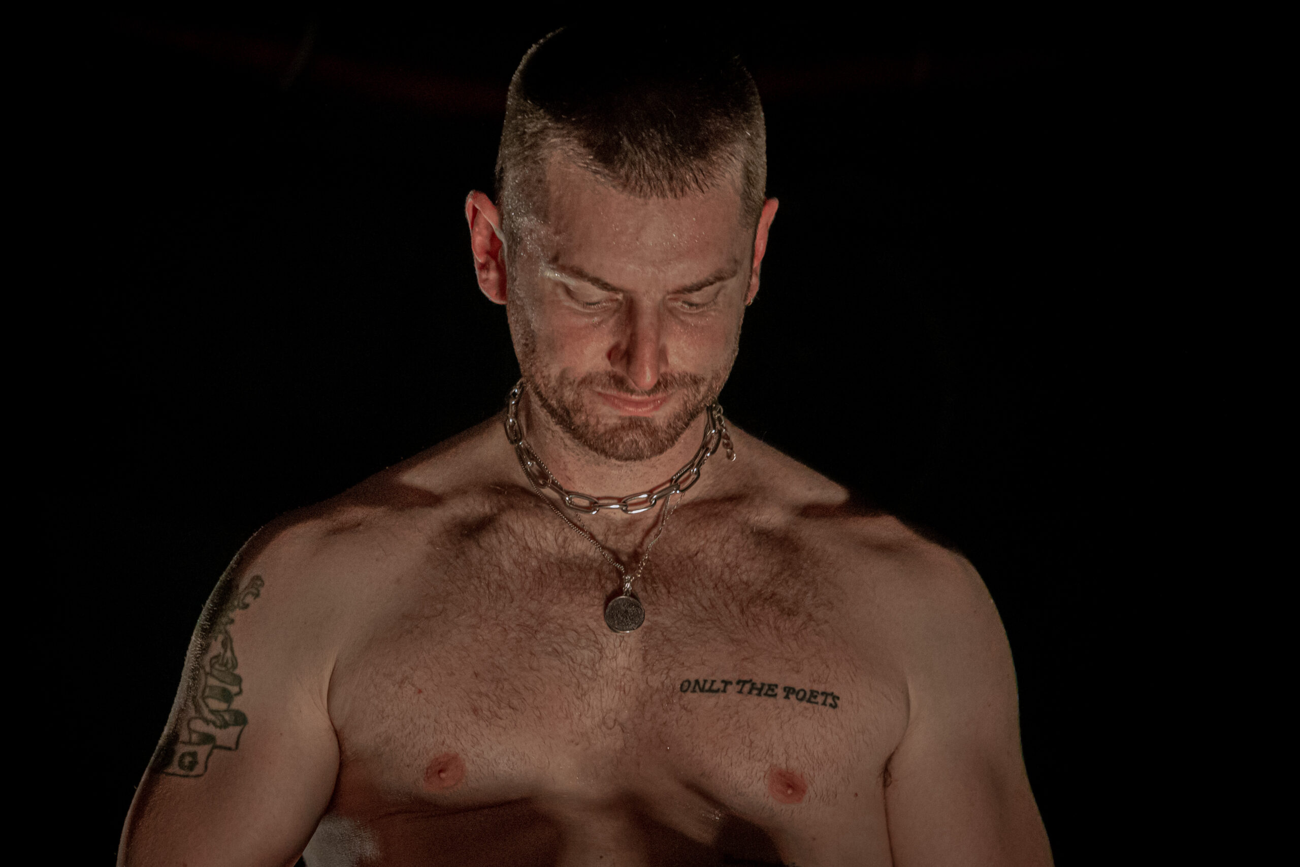 Marc E. Bassy Only the Poets chest tattoo