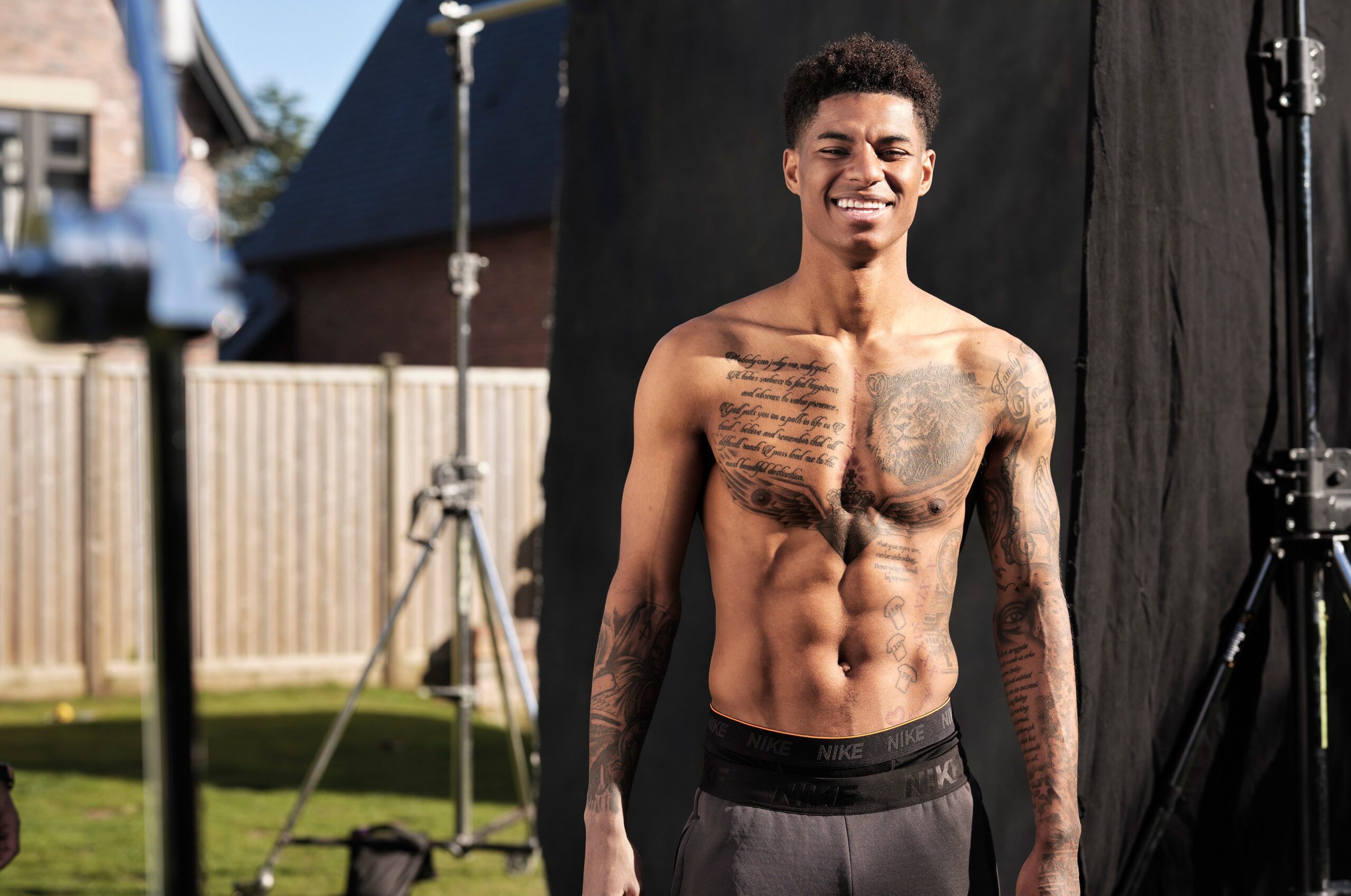 Marcus Rashford chest lion and script tattoos