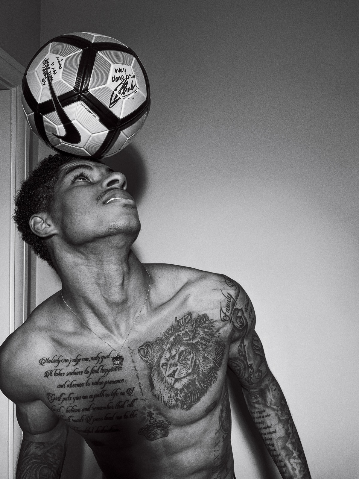 Marcus Rashford script and chest tattoos