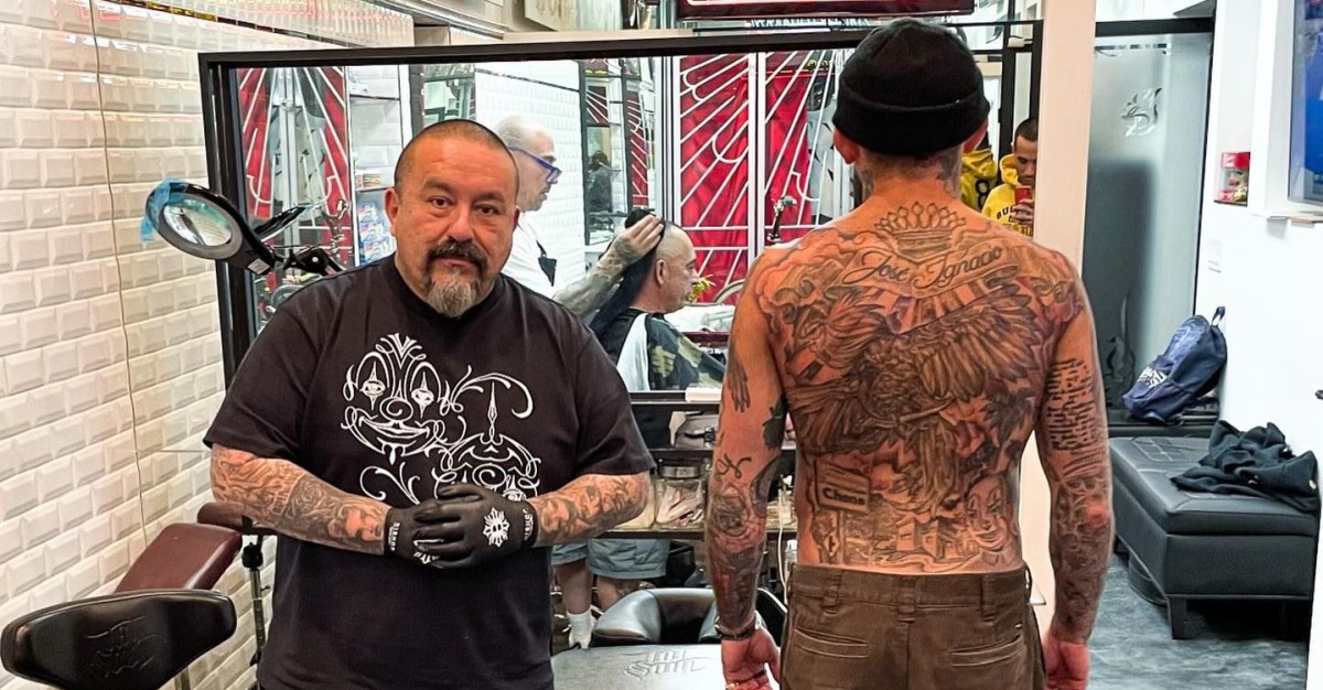 Marlon Vera back tattoo photographed with tattoo artist Mister Cartoon