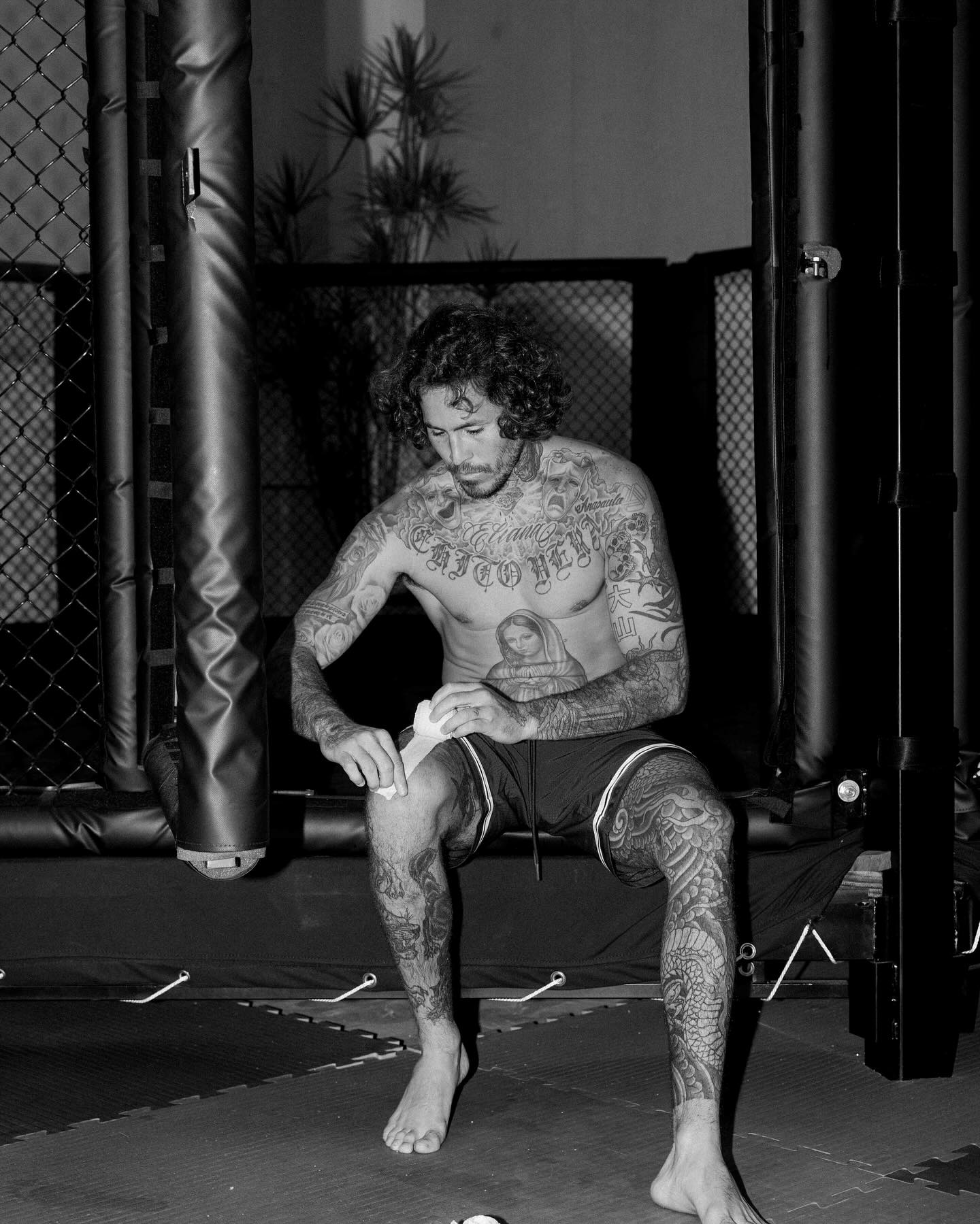 Marlon Vera front tattoos showing chest lettering, Virgin Mary and arm designs