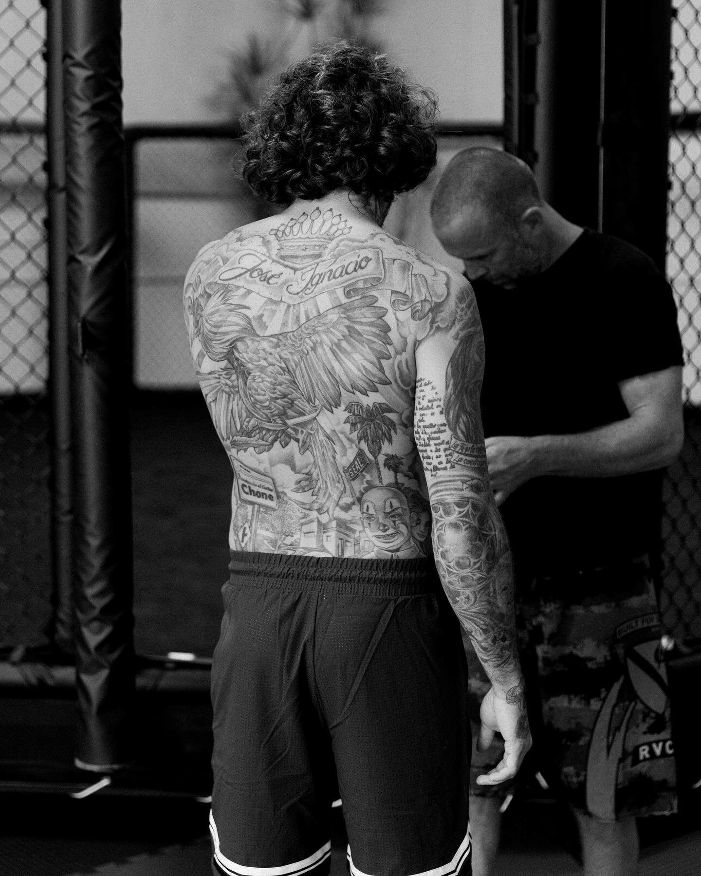 Marlon Vera showing his large back tattoo with Chone lettering and a rooster